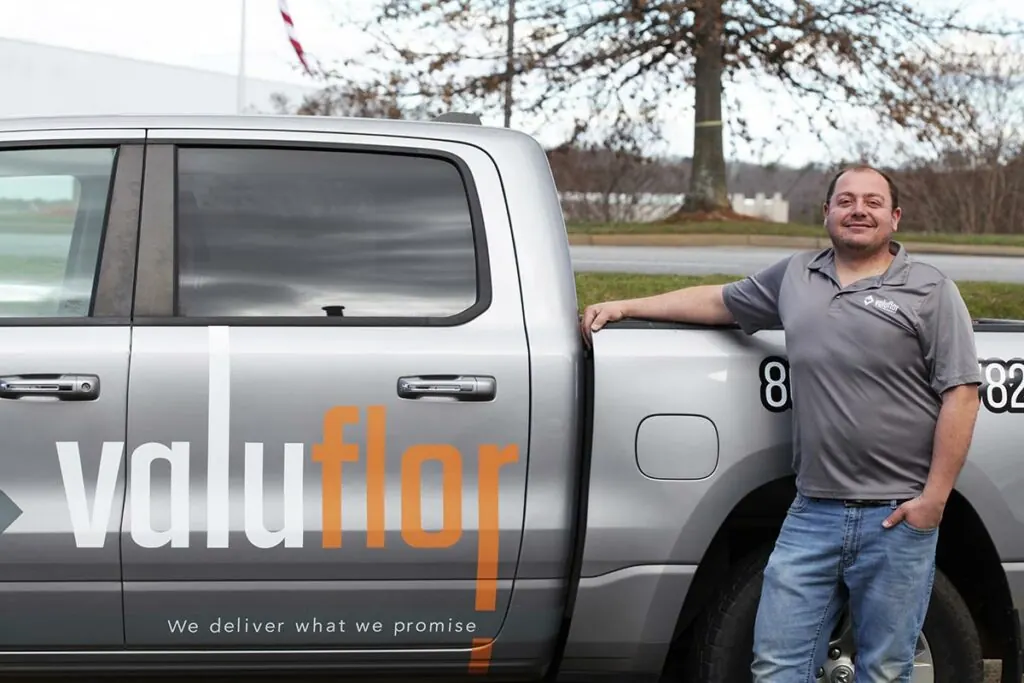 ValuFlor staff member beside a company truck