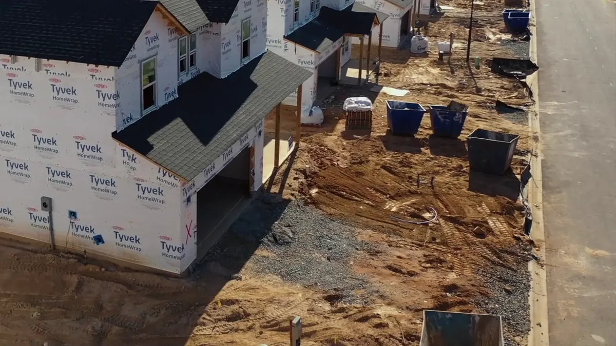 Dumpsters and graded lots on an active jobsite