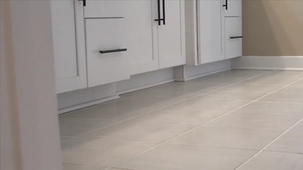 White kitchen cabinets over a light tile floor