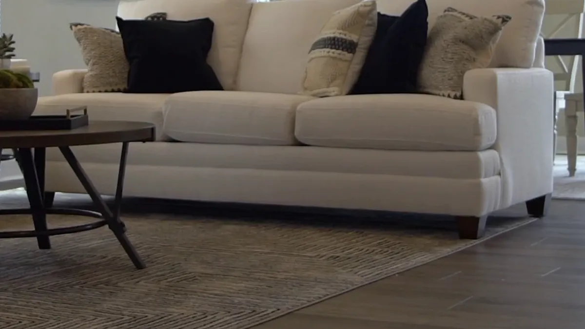 Coffee table and rug on a plank floor in a delivered home