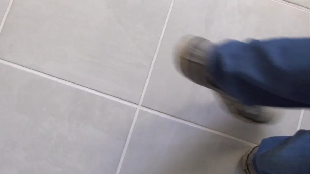 A step across a finished light gray tile floor